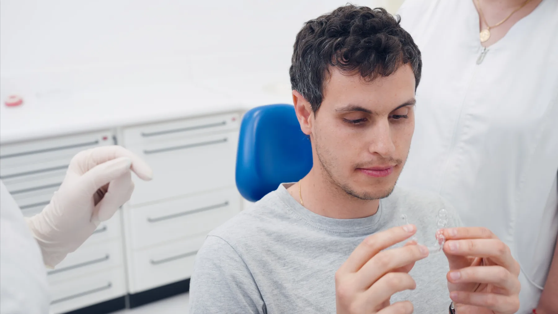 Adult patient discussing clear-aligner treatment with a dentist
