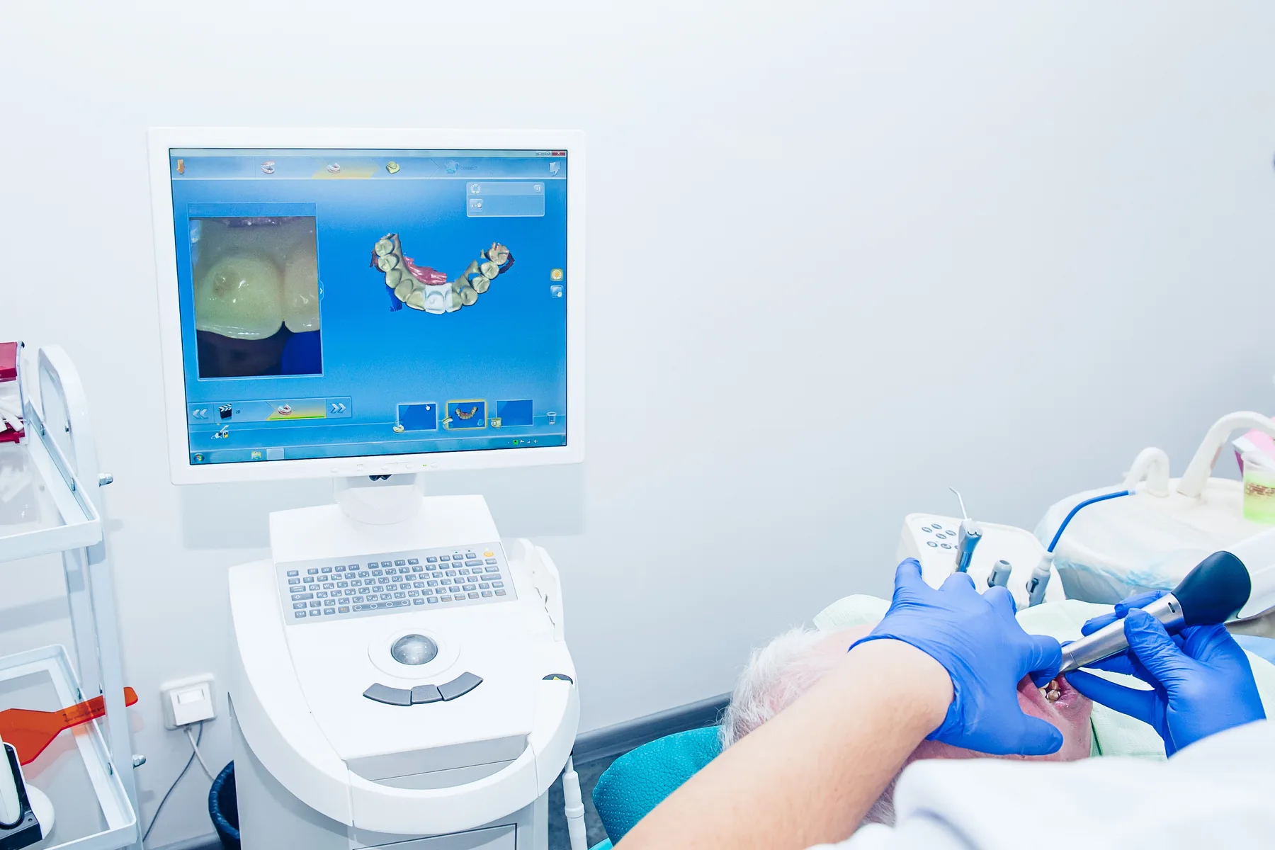Dental laboratory professional designing a custom bridge with CAD CAM technology