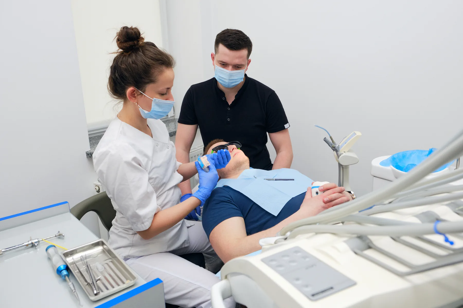 Dentist checking the fit of a custom dental crown with a patient