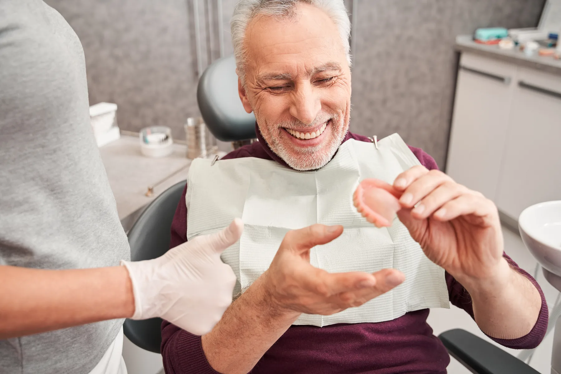 Dentist reviewing dentures with a senior patient
