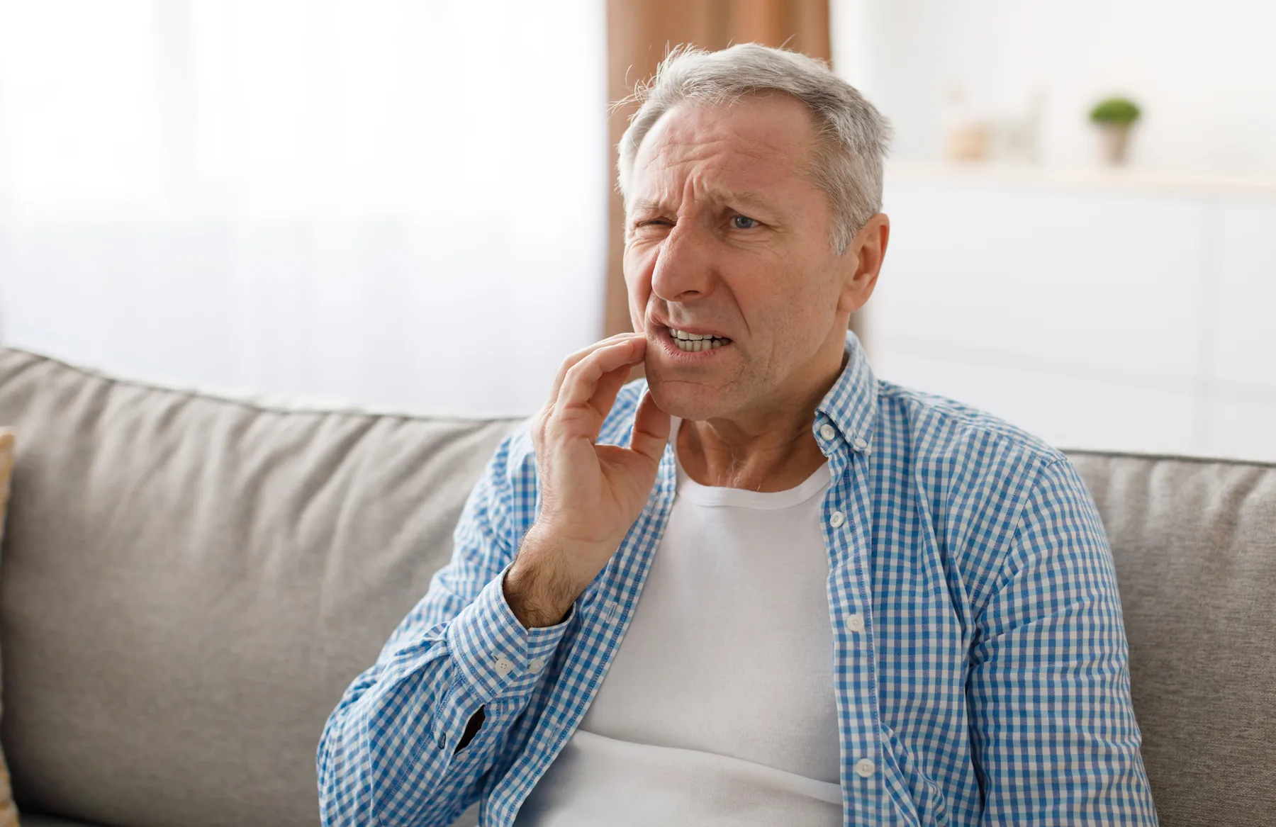 Adult patient experiencing acute dental pain at home