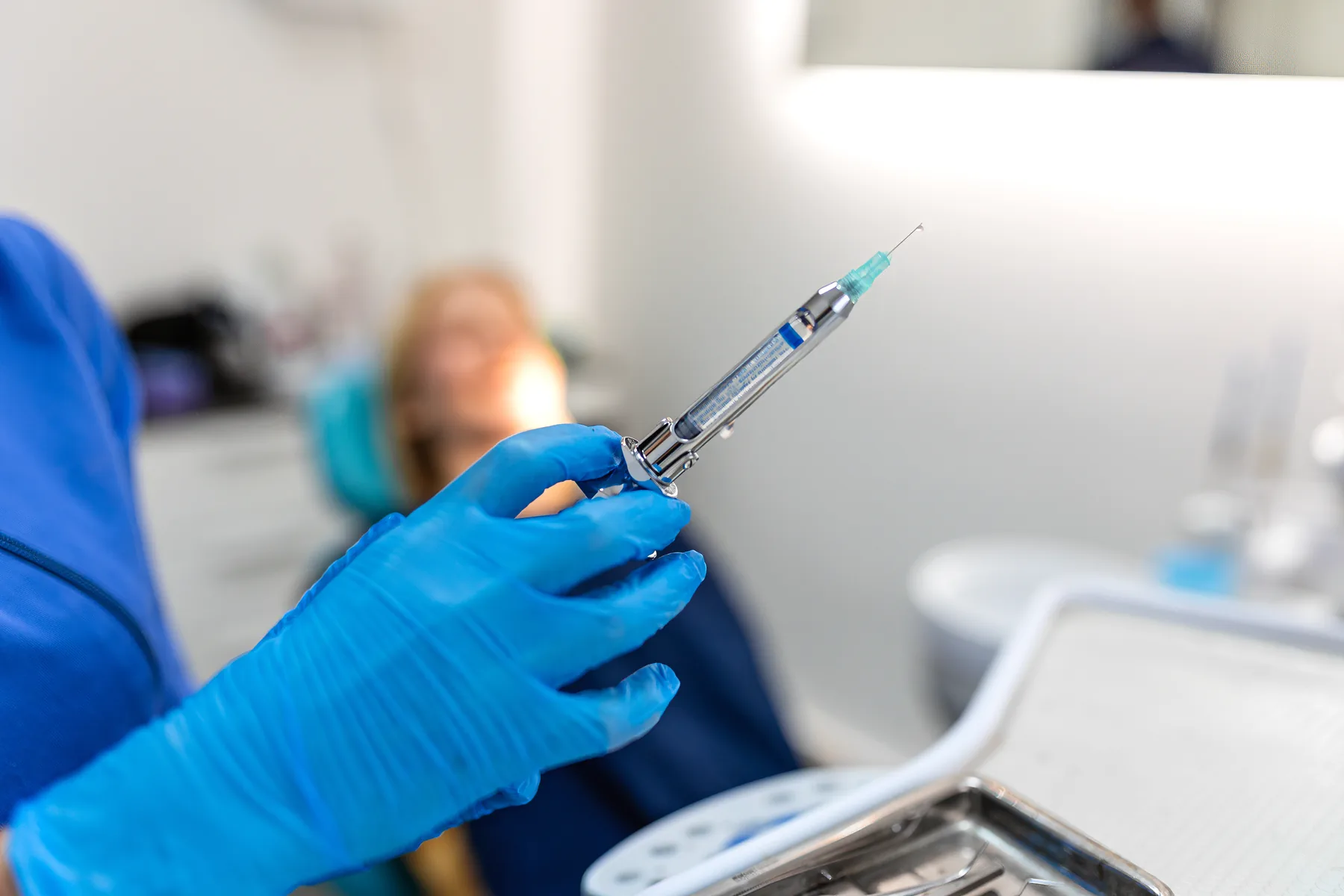 Dentist preparing local anesthesia before a tooth extraction