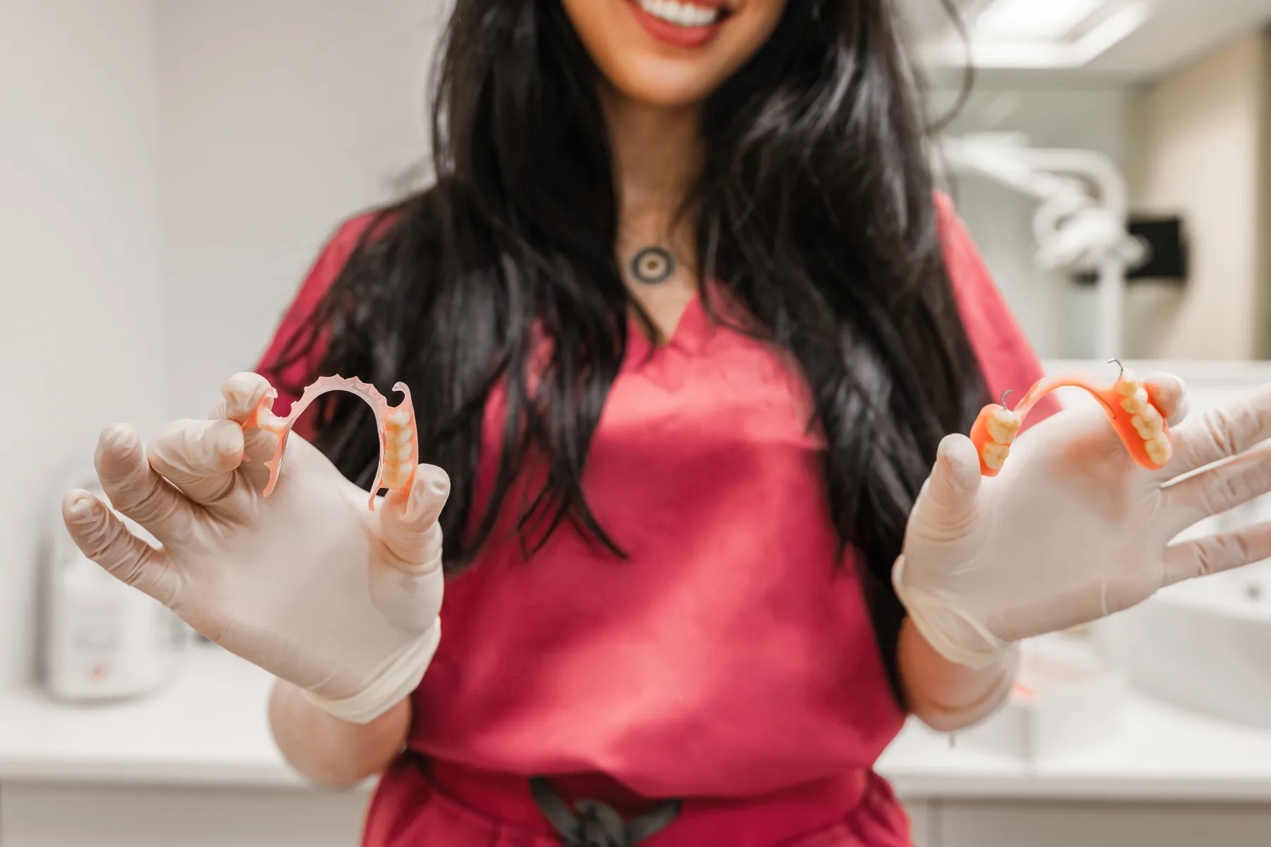 Dental professional presenting two removable partial denture options