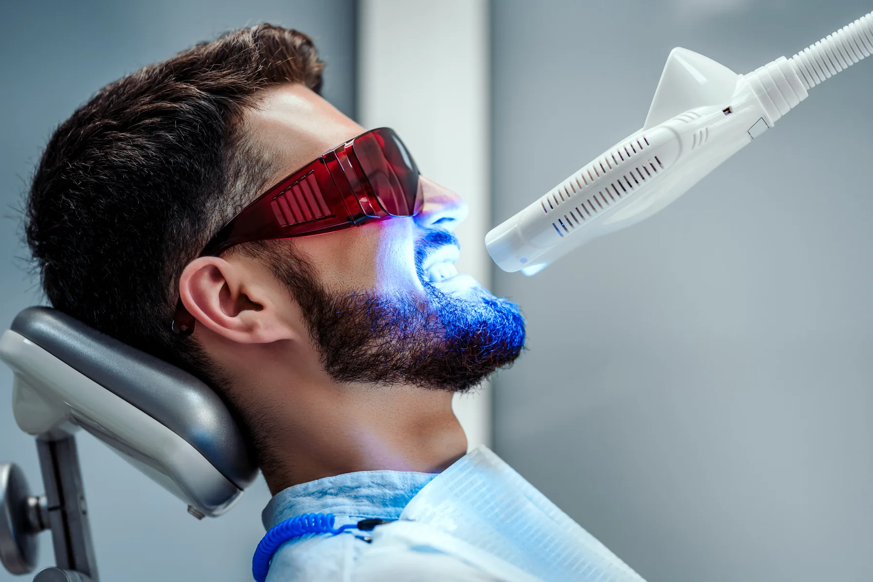 Dentist performing professional in-office teeth whitening treatment