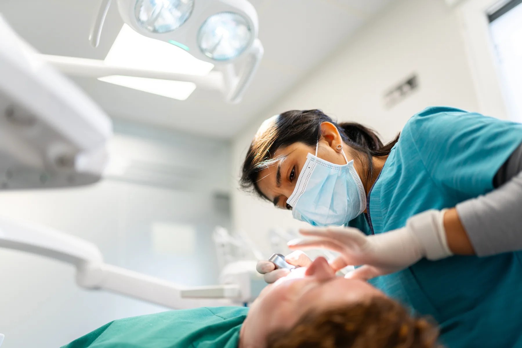 Dentist completing a routine oral examination in a modern dental clinic