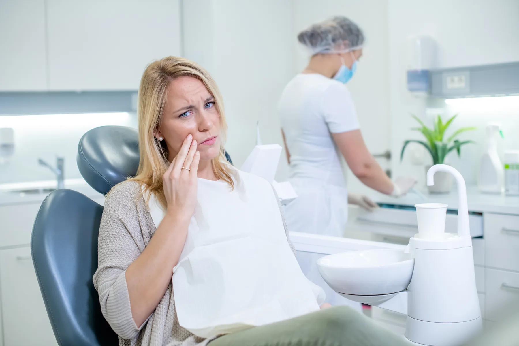 Dentist preparing to examine a patient experiencing an urgent toothache