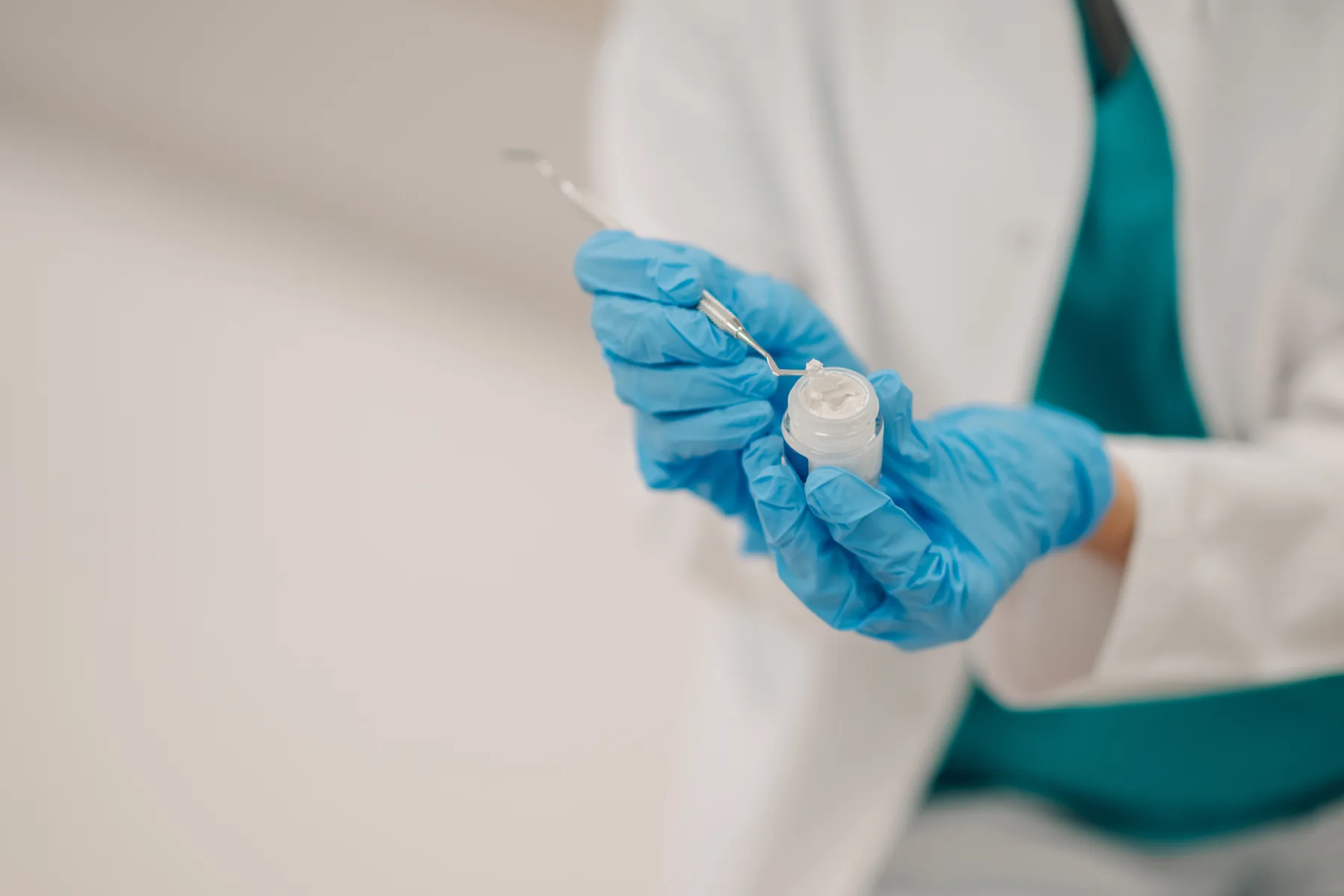 Dentist preparing tooth-colored composite material for a dental filling