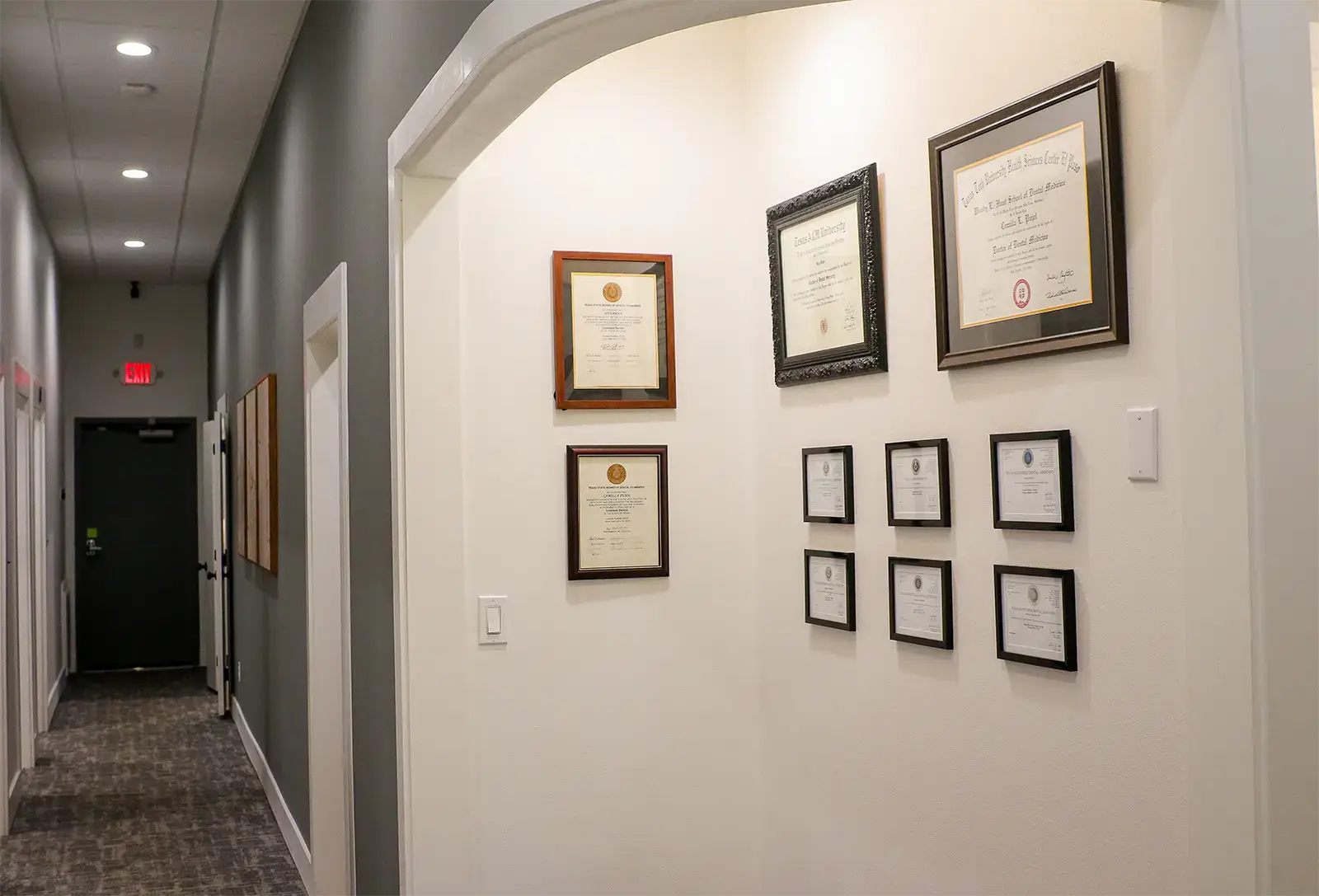 Professional credentials displayed in the Troup Family Dental hallway
